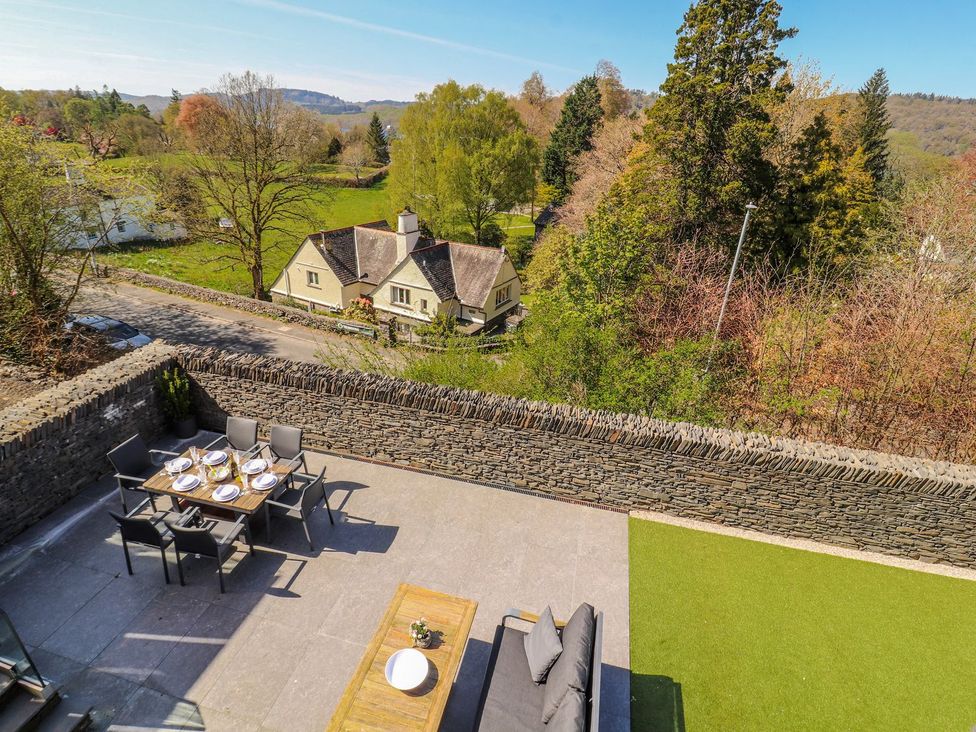An outdoor dining area with a table and chairs at Midways in Windermere