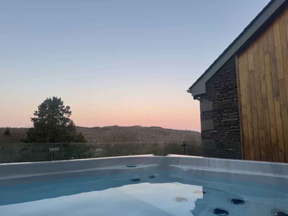 A hot tub with a view of the mountains at Midways in Windermere