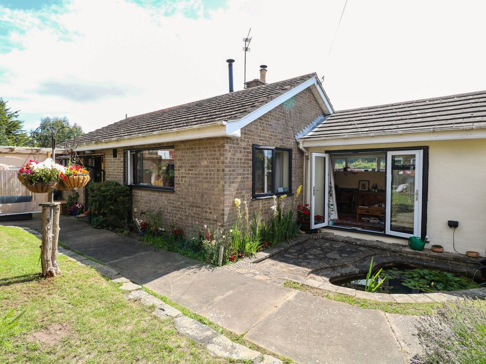 A bungalow with a garden and pathway at The Bungalow in Burgh Castle