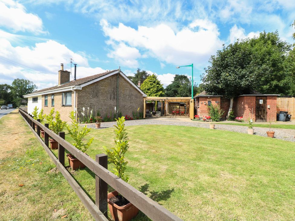 A property with a garden and parking area at The Bungalow in Burgh Castle
