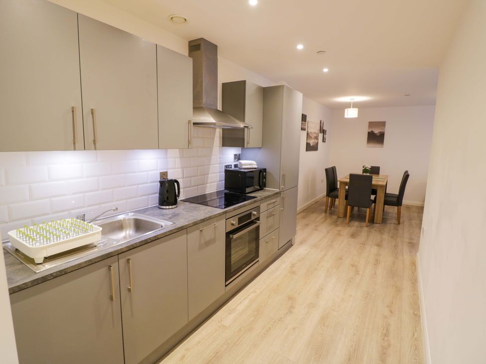 A kitchen with appliances and dining area at Park-View Nook in Birmingham