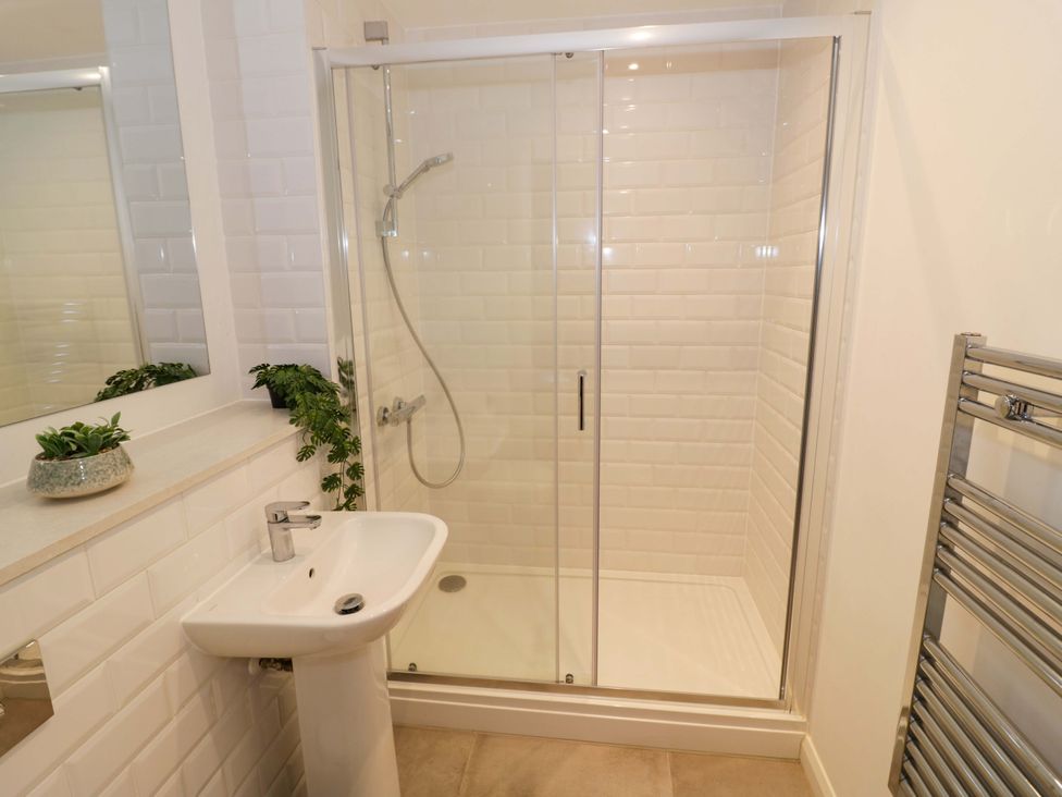 A bathroom with a shower, sink, and towel rail at Park-View Nook in Birmingham