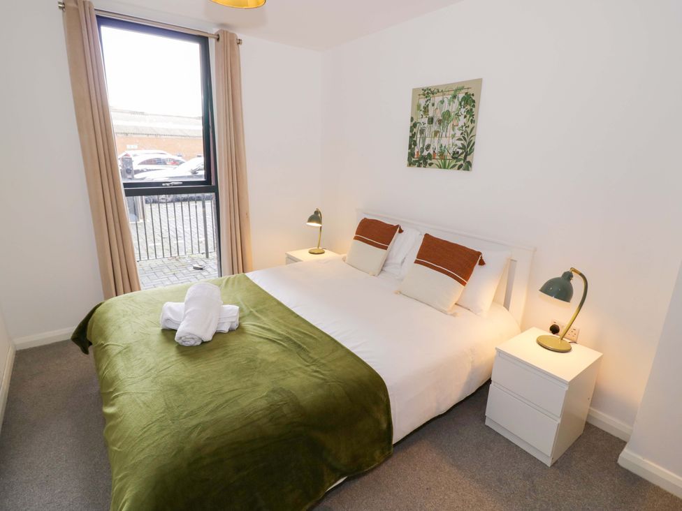 A bedroom with a double bed and nightstand at Park-View Nook in Birmingham