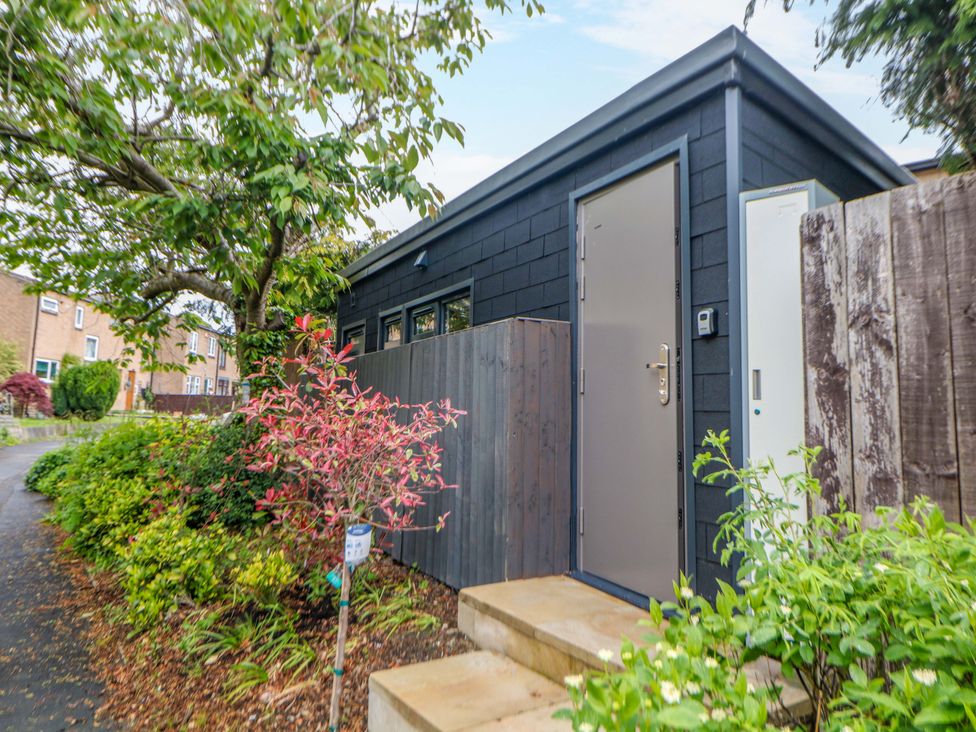 A cabin entrance with steps and plants at Dore Cabin Sheffield