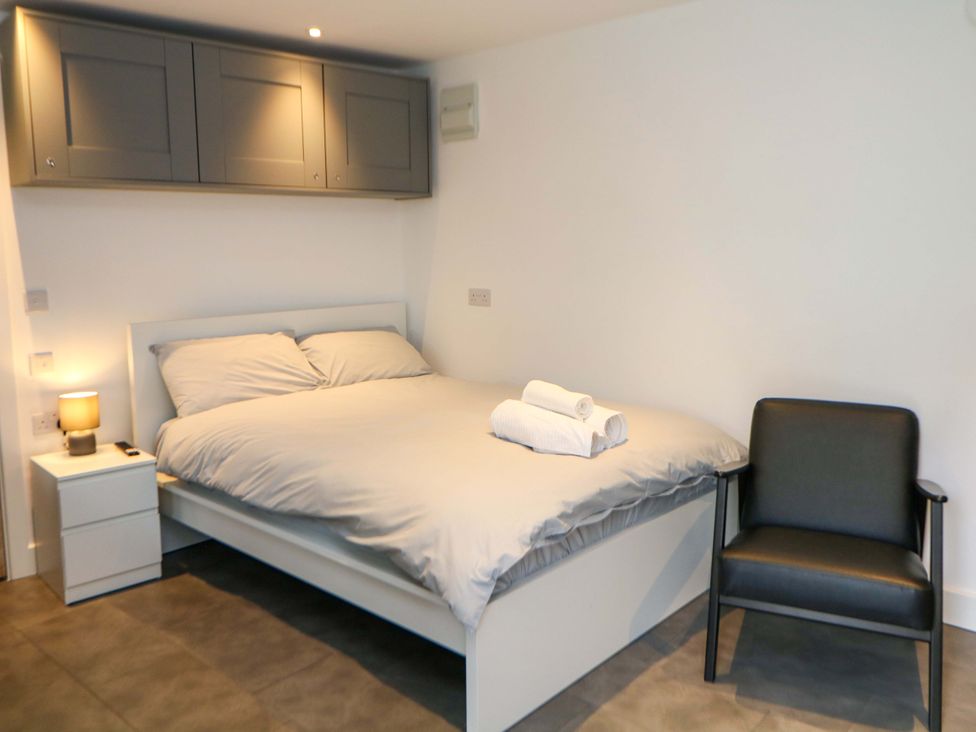 A bedroom with a bed and nightstand at Dore Cabin in Sheffield