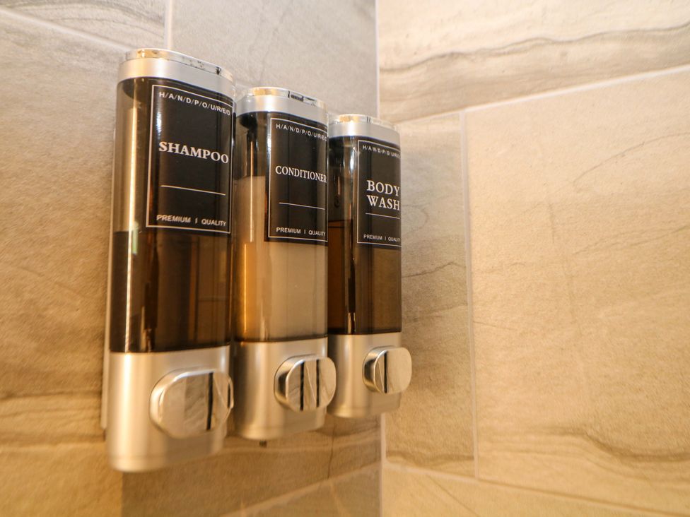 Three dispensers for shampoo, conditioner, and body wash at Dore Cabin in Sheffield