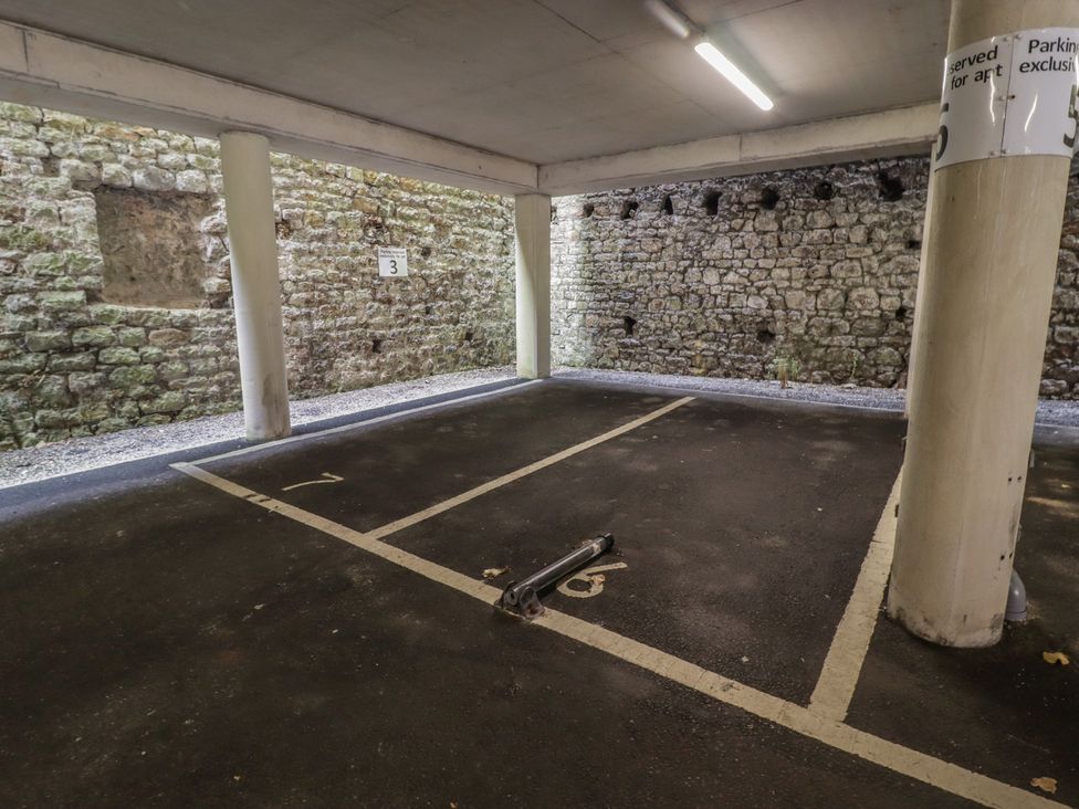 A parking space with stone walls and pillars at Cornstore Cottage in Pembroke
