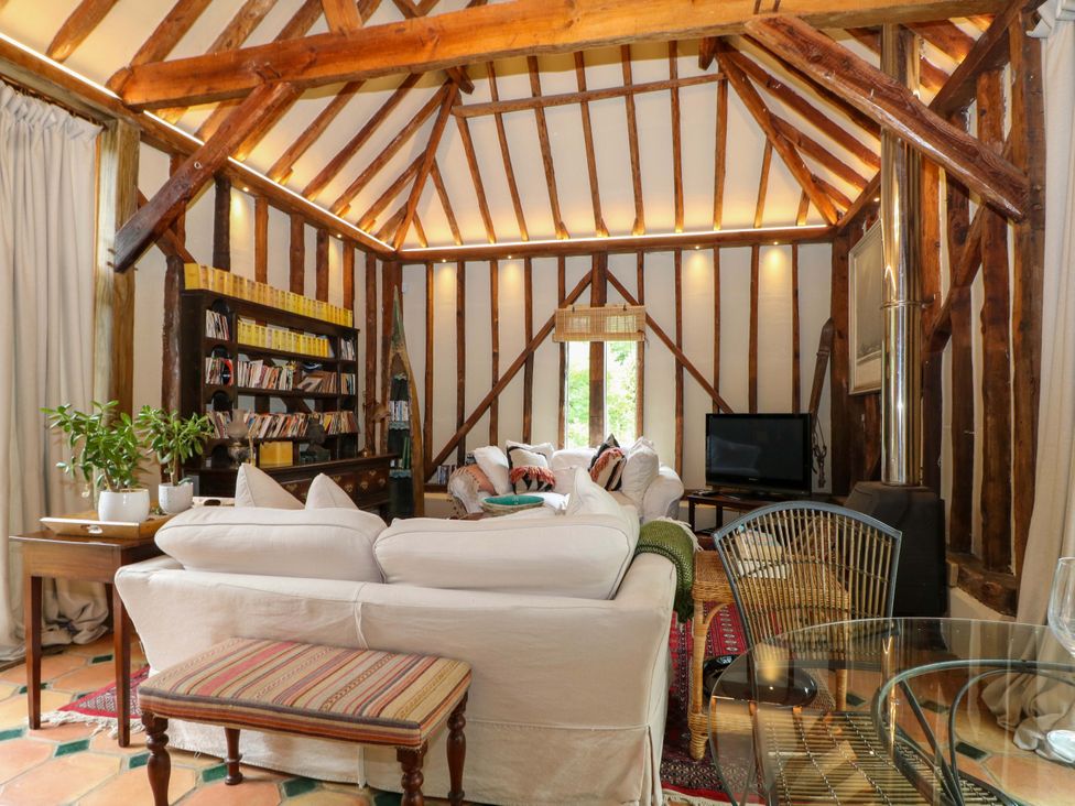 A living room with a couch and a television at Petworth Barn in Petworth