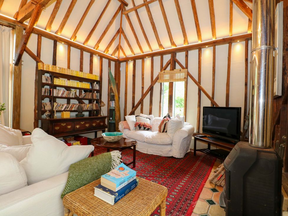 A living room with a sofa and television at Petworth Barn in Petworth