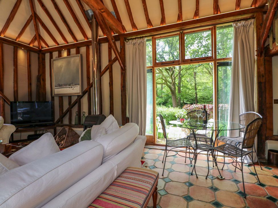 A living room with a sofa and dining table at Petworth Barn in Petworth