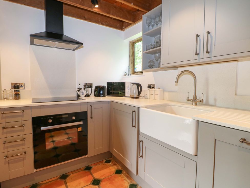 A kitchen with a sink and oven at Petworth Barn in Petworth