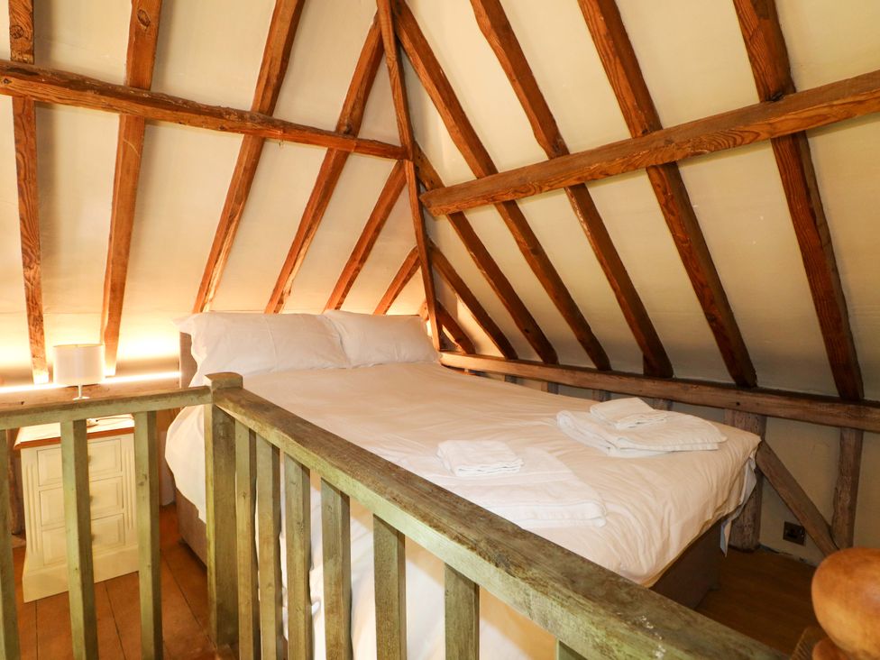 A bedroom with a bed and a bedside table at Petworth Barn in Petworth