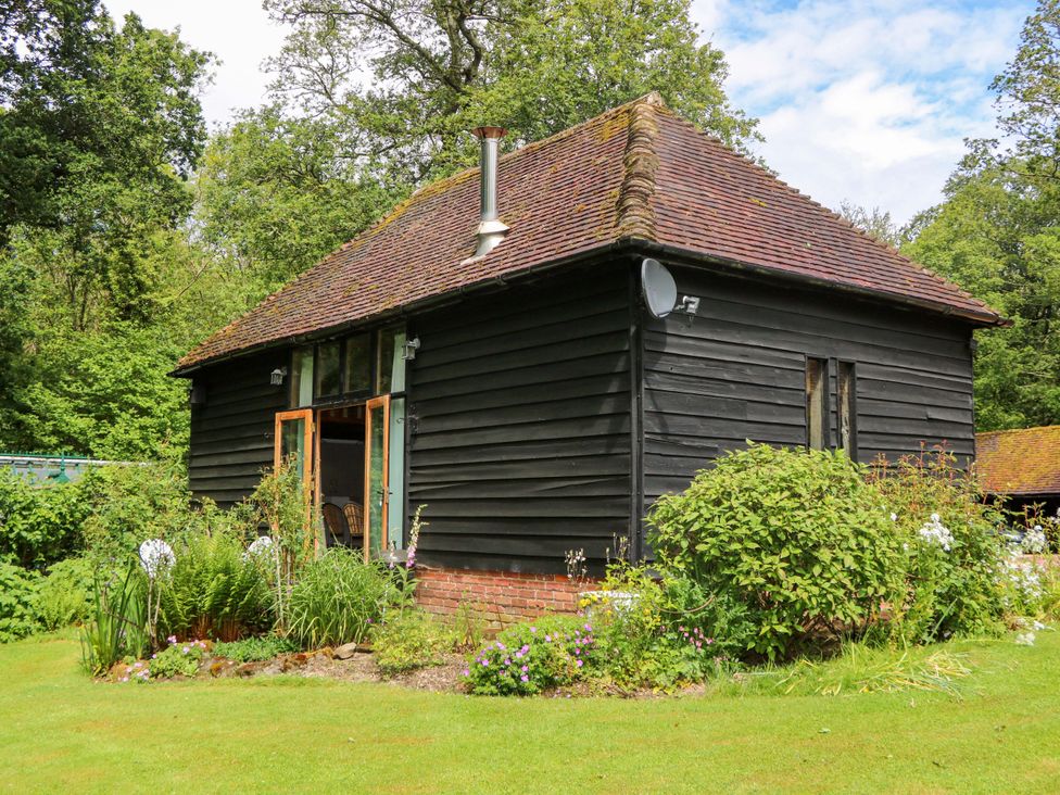 A building with garden plants at Petworth Barn in Petworth