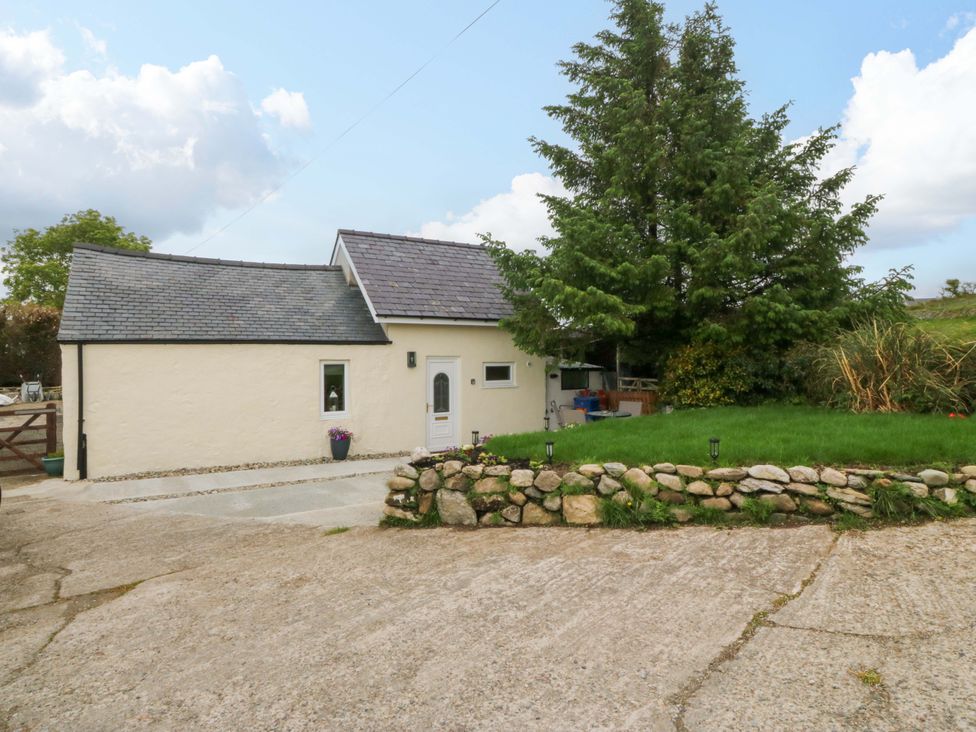 A house with a garden and pathway at Ty Loti