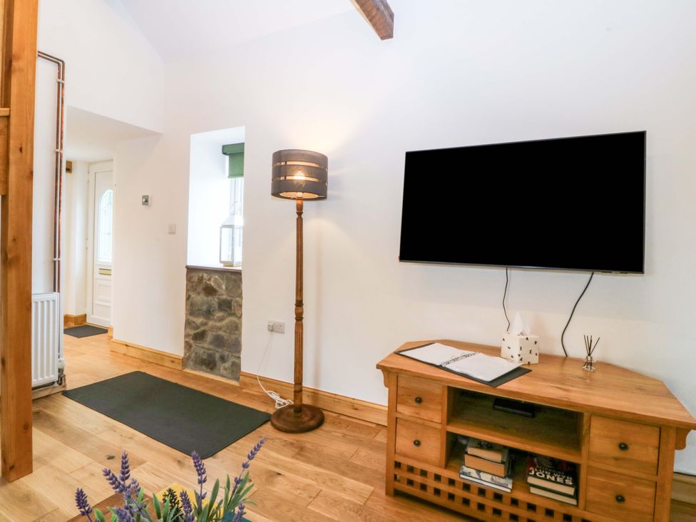 A living room with a television and a side table at Ty Loti