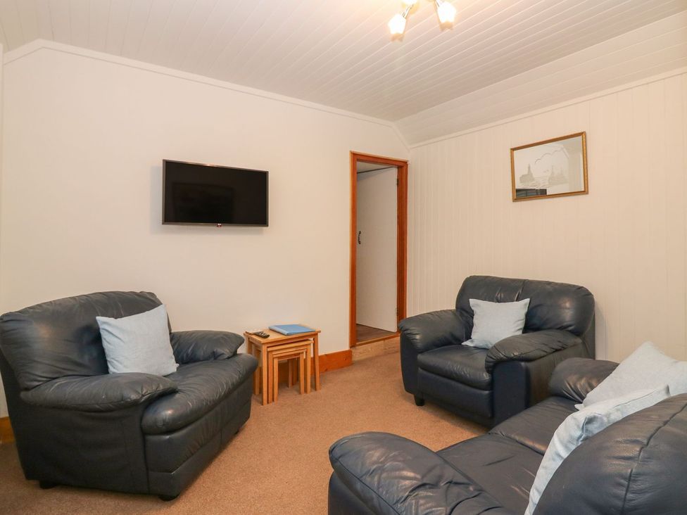 A living room with sofas and a television at Viola Cottage Fraserburgh