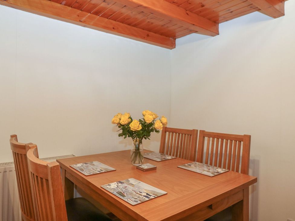 A dining room with a table and chairs at Viola Cottage Fraserburgh