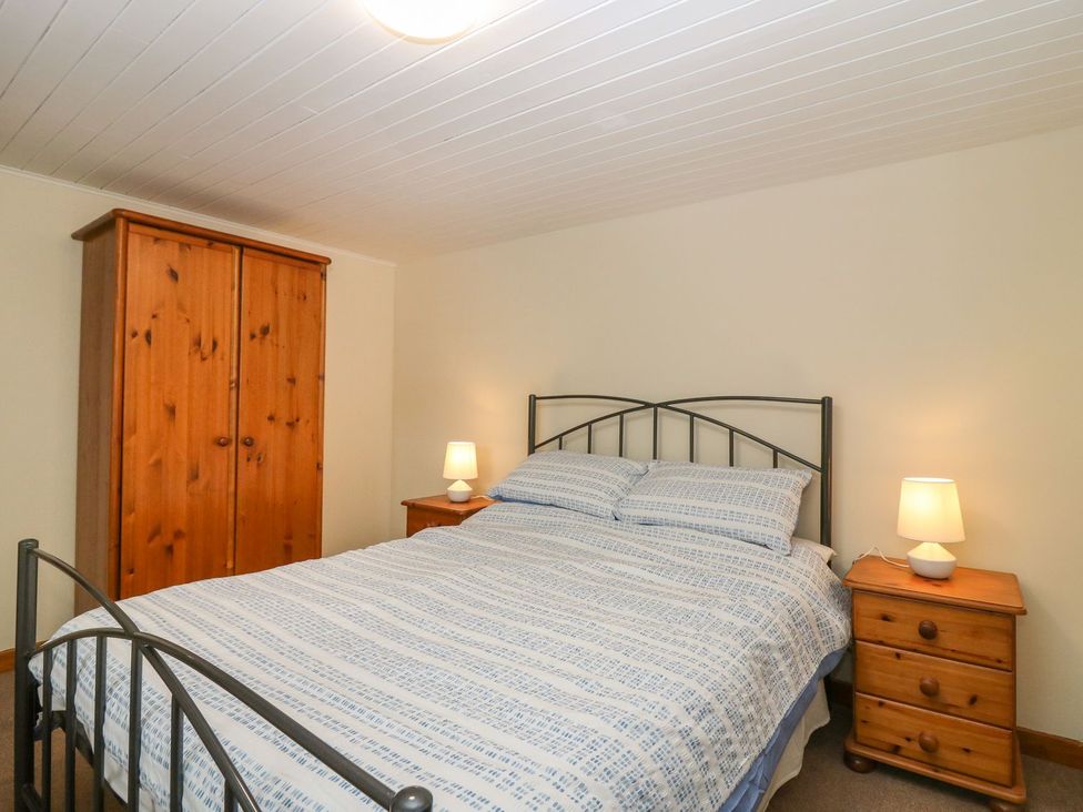 A bedroom with a bed and furniture at Viola Cottage in Fraserburgh