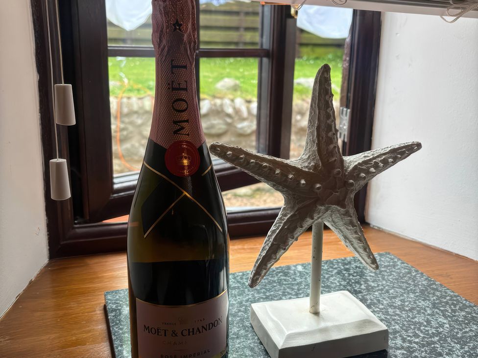 A bottle of Moët & Chandon champagne and a starfish decoration by a window at Viola Cottage St Combs near Fraserburgh
