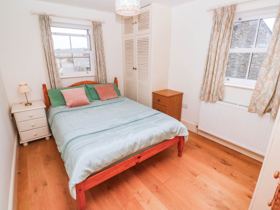 A bedroom with a bed and furniture at Chyrose Farmhouse in Pendeen