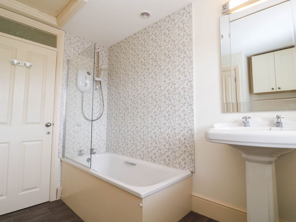 A bathroom with a bathtub and a sink at Chyrose Farmhouse in Pendeen