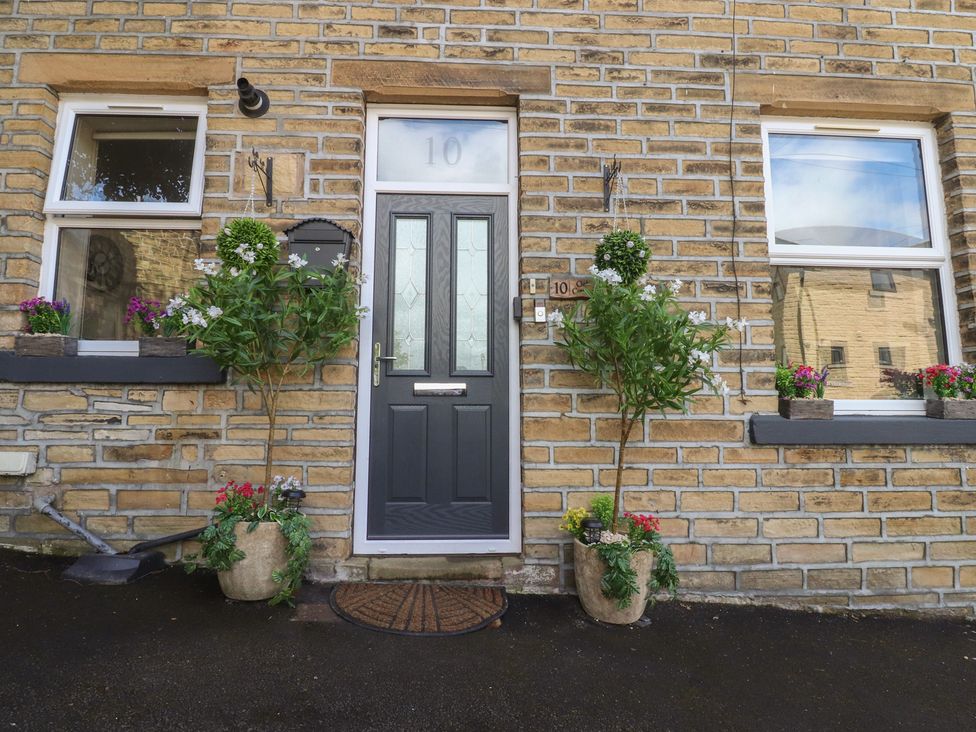A front entrance with plants and a door at 10 Oak Street in Keighley