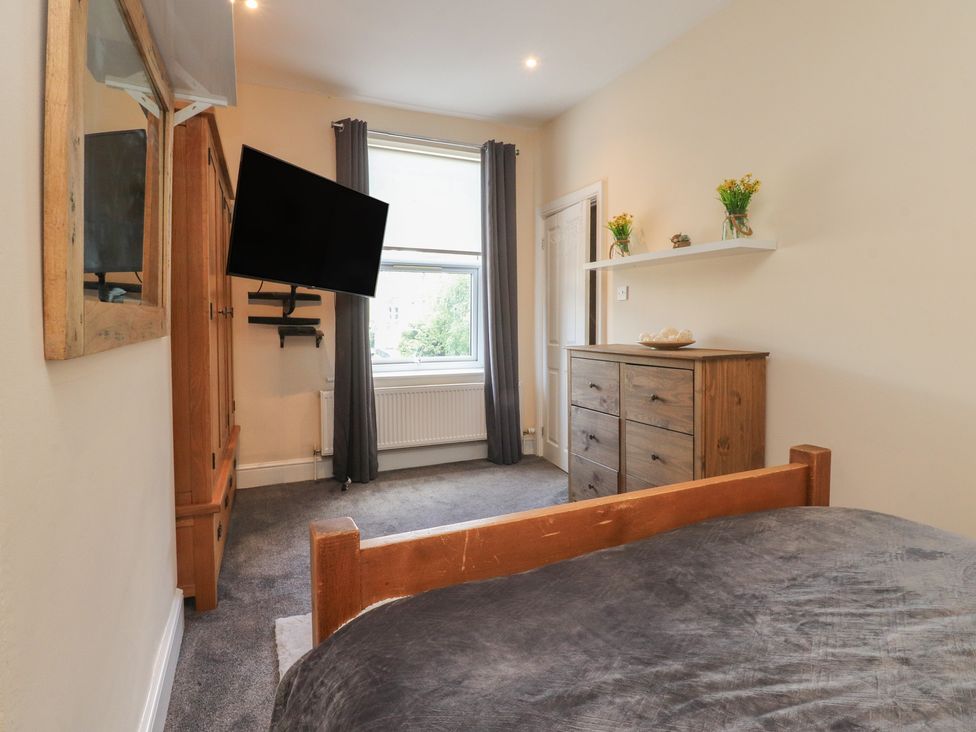A bedroom with a television and a dresser at 10 Oak Street in Keighley