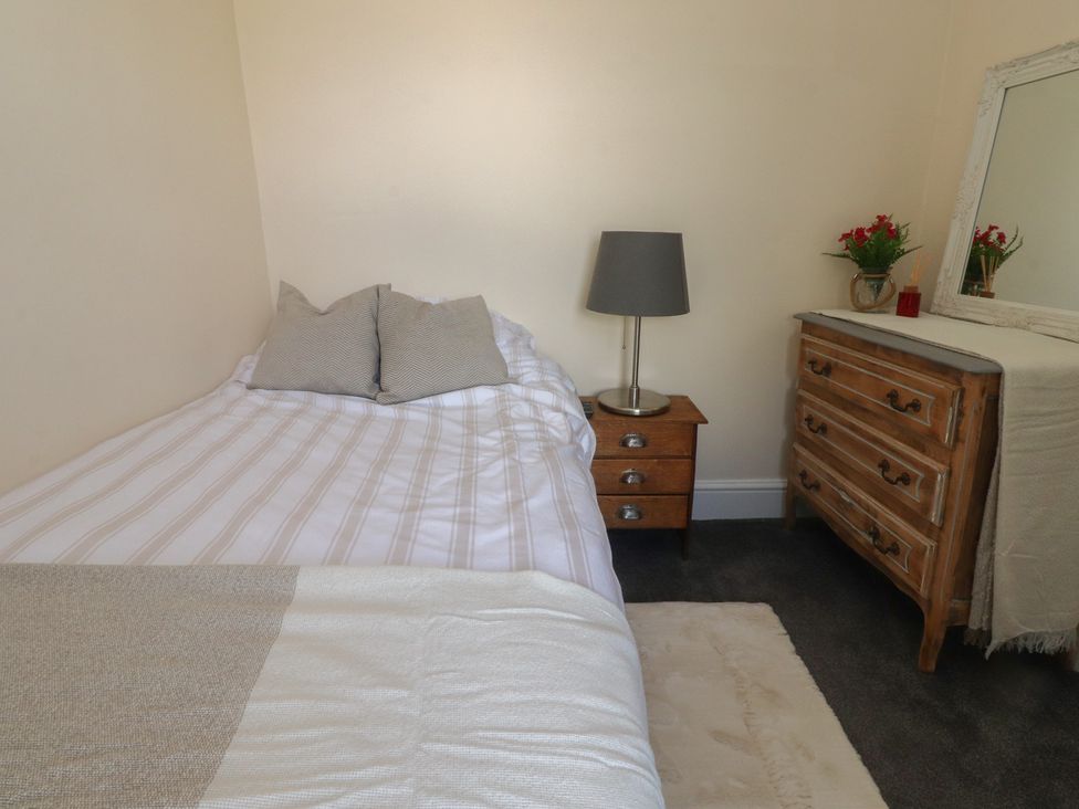 A bedroom with a bed and dresser at 10 Oak Street in Keighley