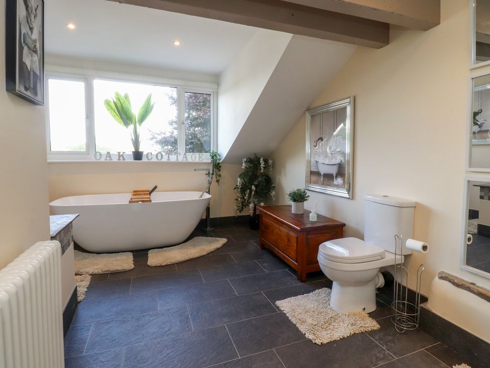 A bathroom with a bathtub and toilet at 10 Oak Street in Keighley