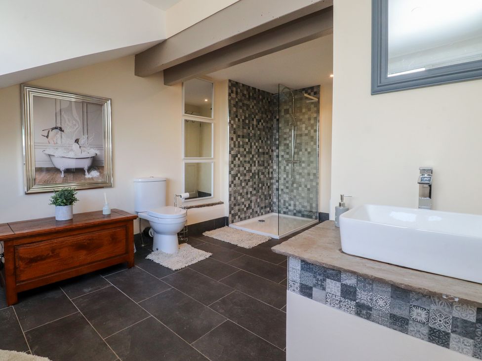 A bathroom with a shower and bathtub at 10 Oak Street in Keighley