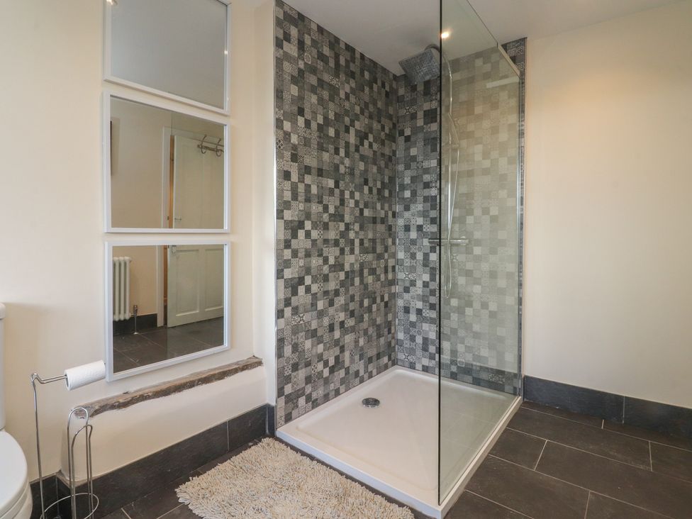 A bathroom with a shower and toilet at 10 Oak Street Keighley