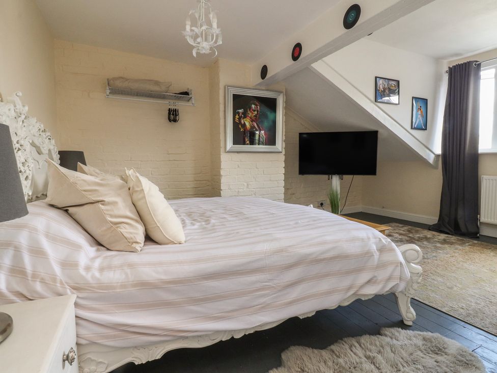 A bedroom with a bed and television at 10 Oak Street in Keighley