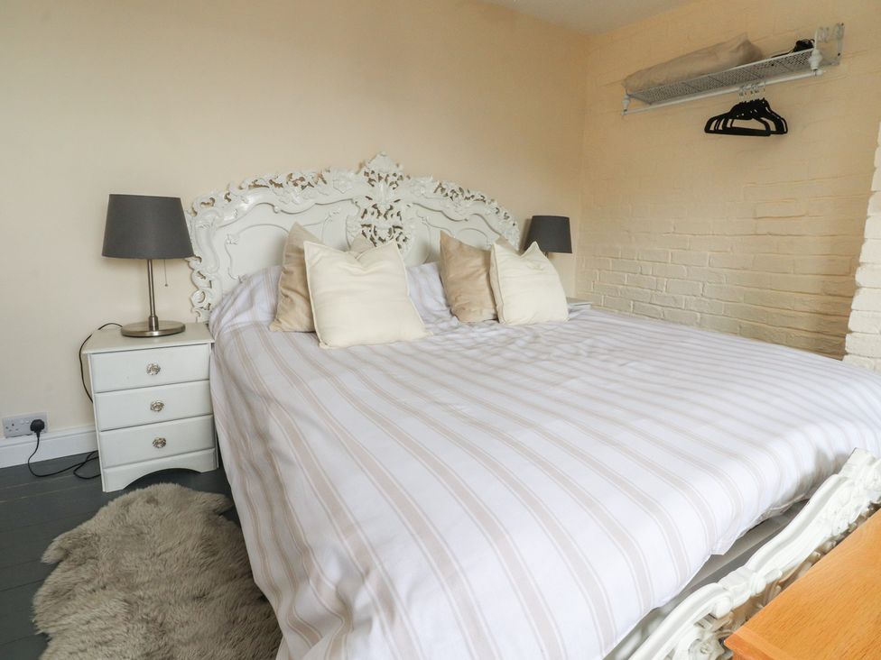 A bedroom with a bed and nightstand at 10 Oak Street in Keighley