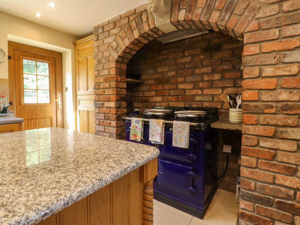 A kitchen with an oven and island at Sheephouse Farm in Bacup