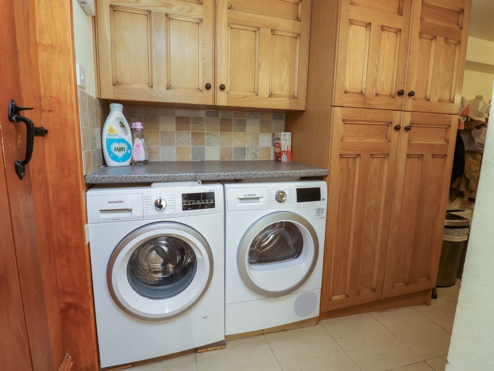 A laundry room with washing machine and dryer at Sheephouse Farm in Bacup