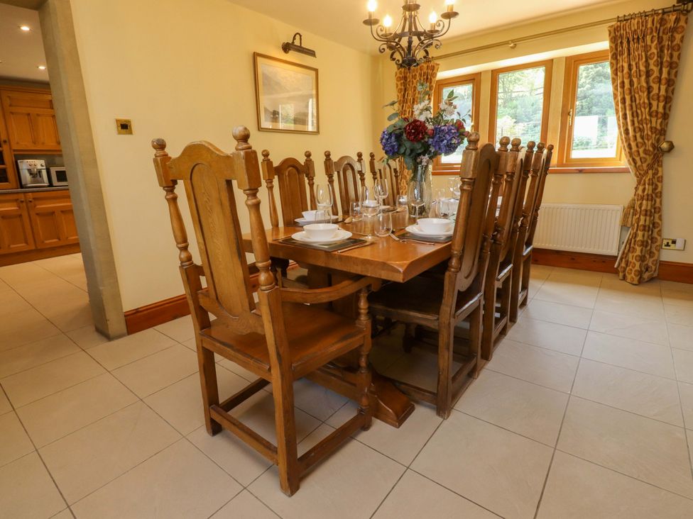 A dining room with a large table and chairs at Sheephouse Farm in Bacup