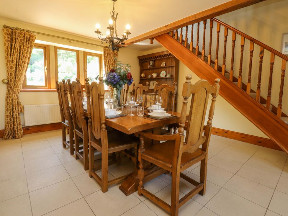 A dining room with a wooden table and chairs at Sheephouse Farm in Bacup