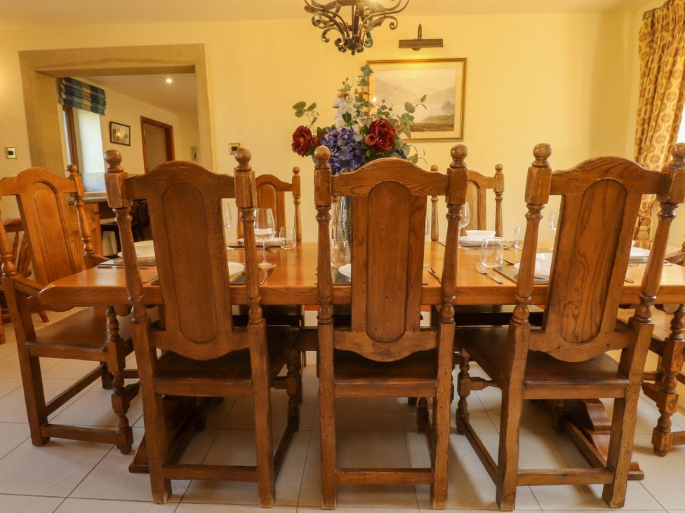 A dining room with a wooden table and chairs at Sheephouse Farm in Bacup