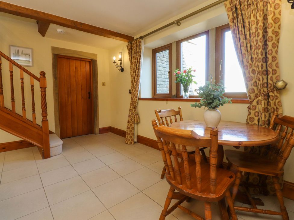 A dining room with a table and chairs at Sheephouse Farm in Bacup