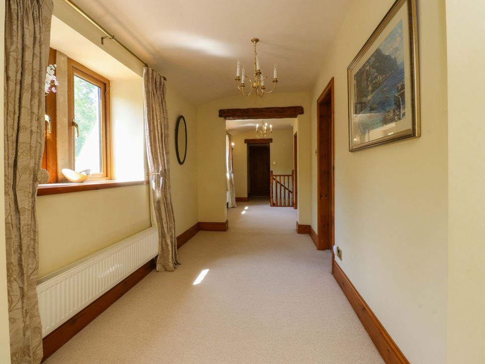 A hallway with windows and light fixture at Sheephouse Farm in Bacup