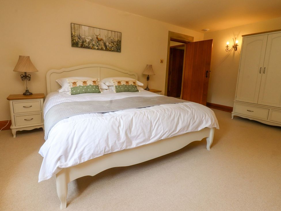 A bedroom with a bed and lamps at Sheephouse Farm in Bacup
