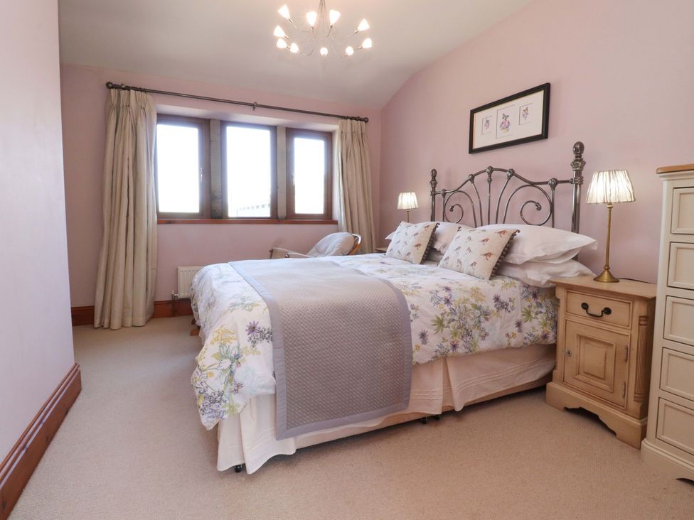 A bedroom with a bed and bedside lamps at Sheephouse Farm in Bacup