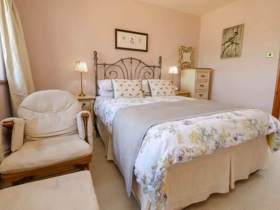 A bedroom with a bed and chair at Sheephouse Farm in Bacup