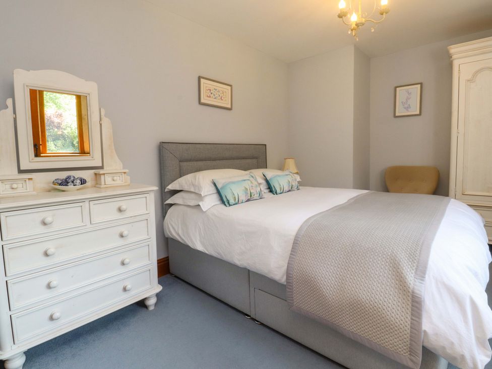 A bedroom with a bed and dresser at Sheephouse Farm in Bacup