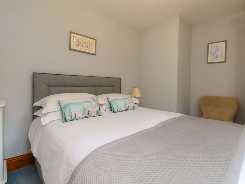 A bedroom with a bed and chair at Sheephouse Farm in Bacup