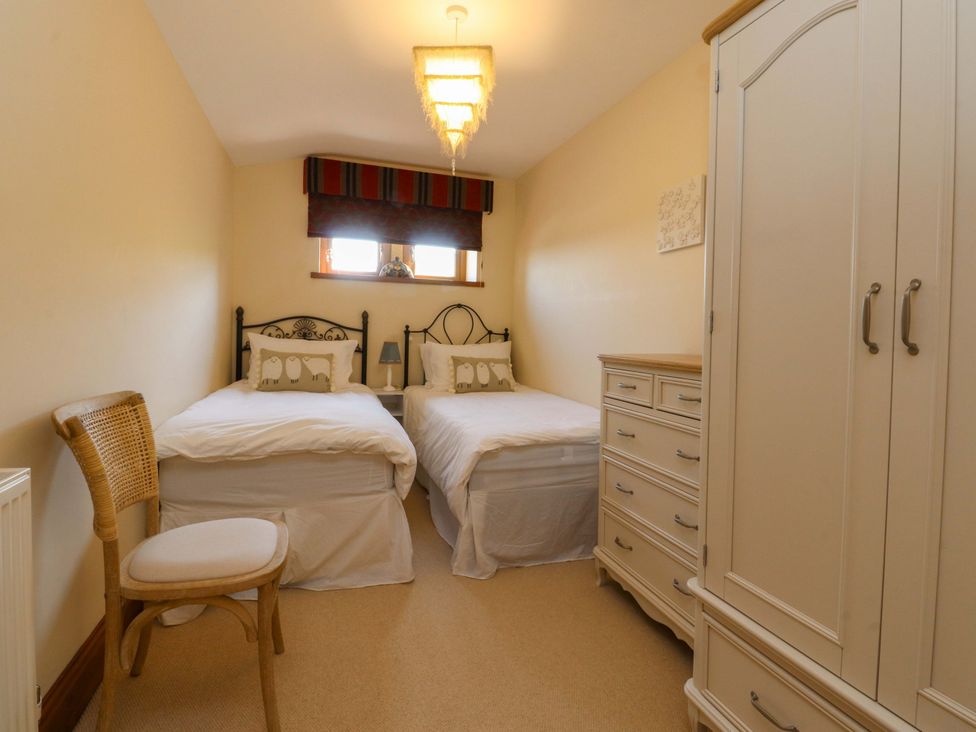A bedroom with twin beds and a wardrobe at Sheephouse Farm in Bacup