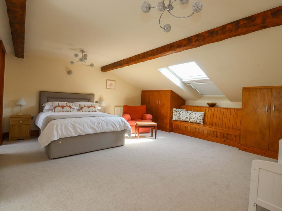 A bedroom with a bed and seating area at Sheephouse Farm in Bacup