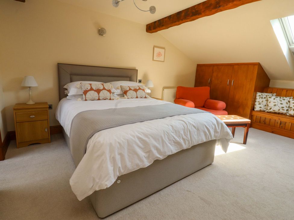 A bedroom with a bed and sofa at Sheephouse Farm in Bacup