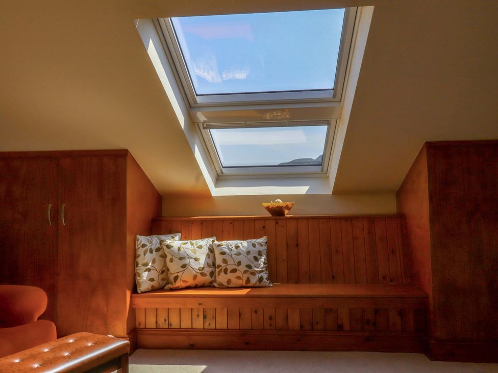 A seating area with cushions and a skylight at Sheephouse Farm in Bacup