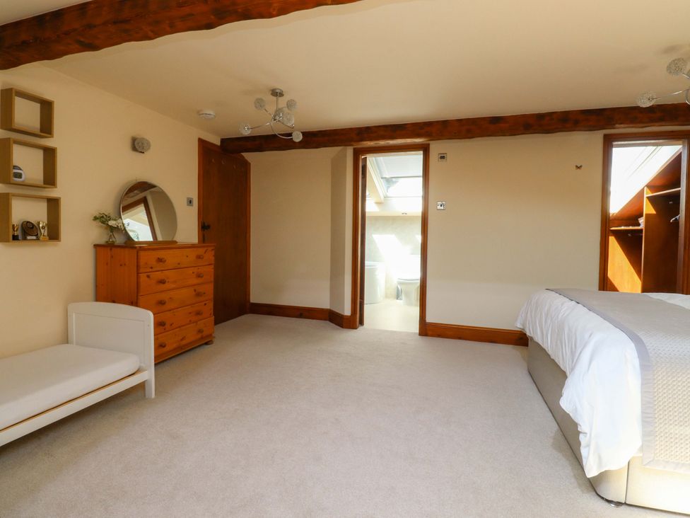 A bedroom with a bed and dresser at Sheephouse Farm in Bacup